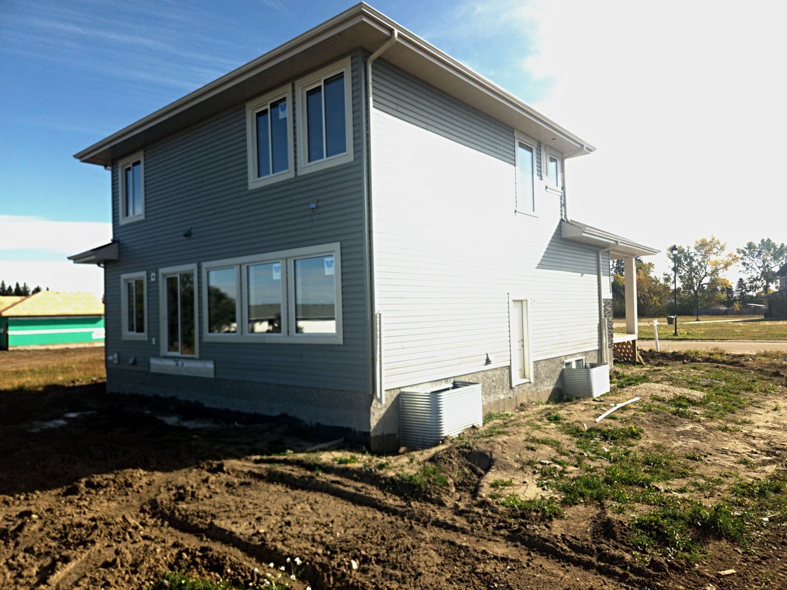 Rear of the Olivia with grey-green lap siding and a row of main-floor windows facing the back yard