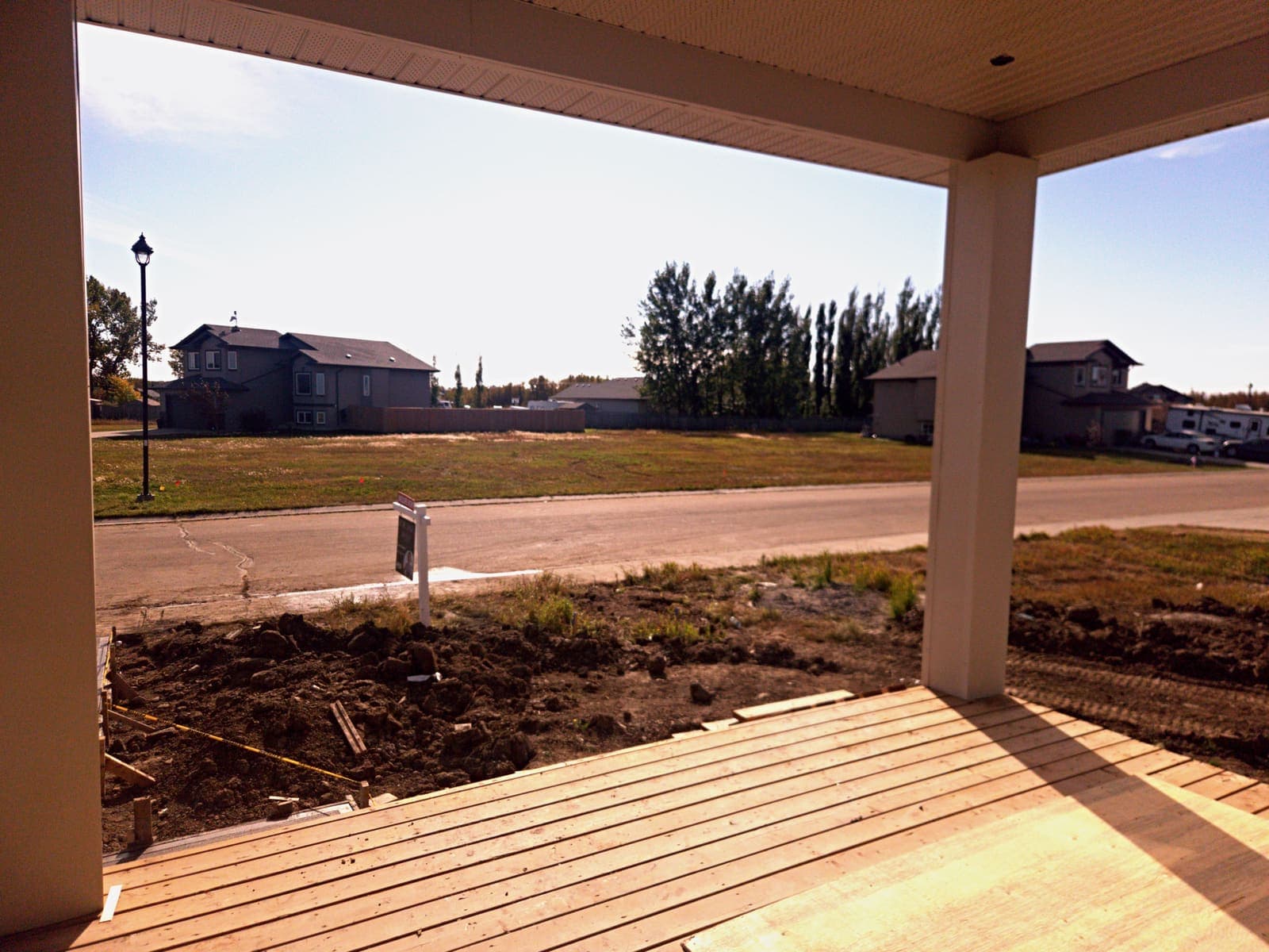 View from the covered veranda out to the street and the neighbouring new homes